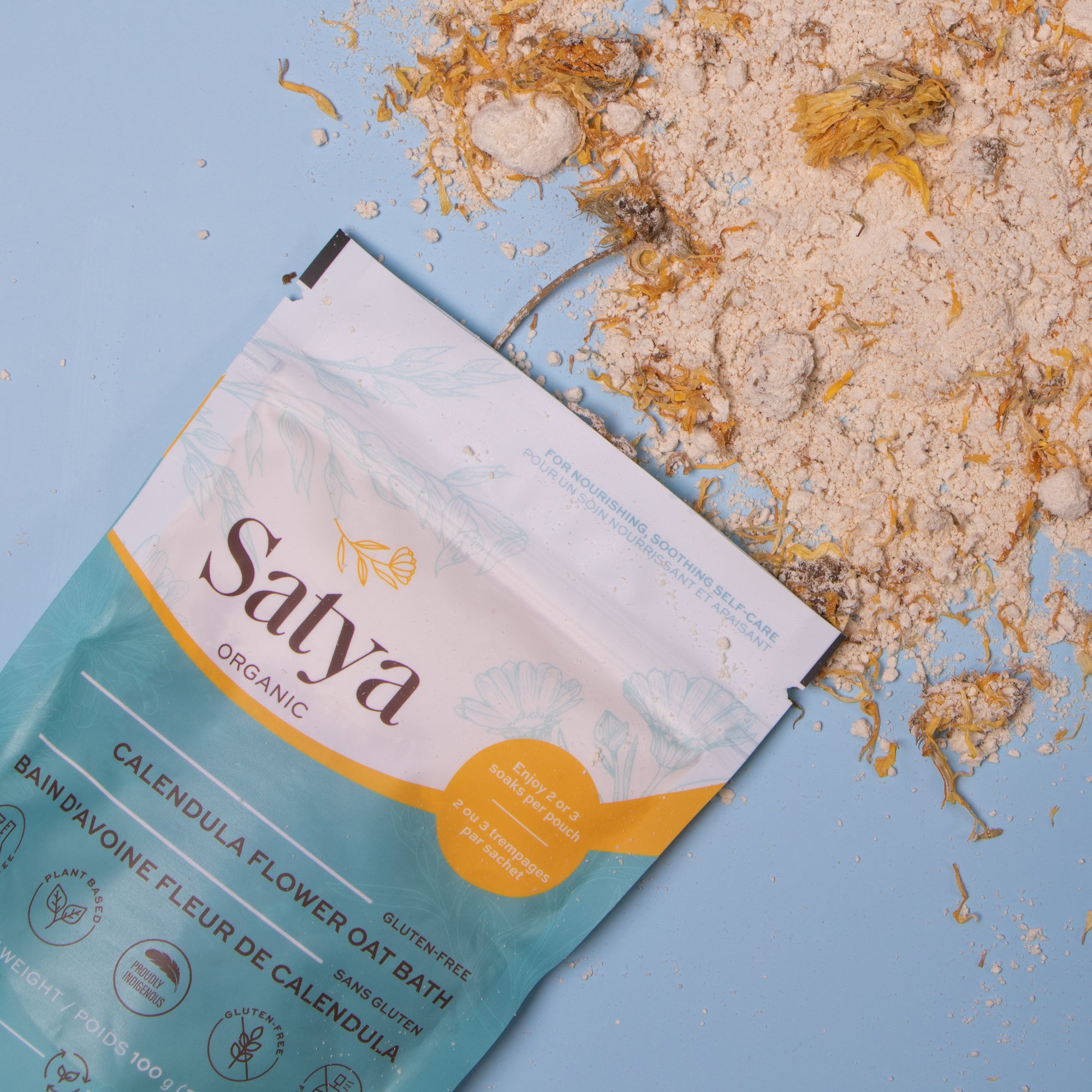 Satya Calendula Flower Oat Bath package with the contents spilled out.
